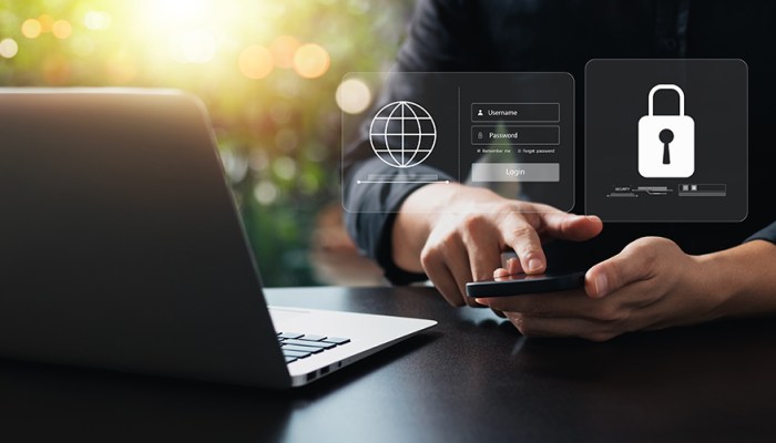 Small business employee using MFA on their phone to safeguard against cybersecurity threats