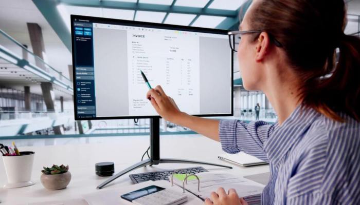 Woman pointing at a screen depicting an invoice