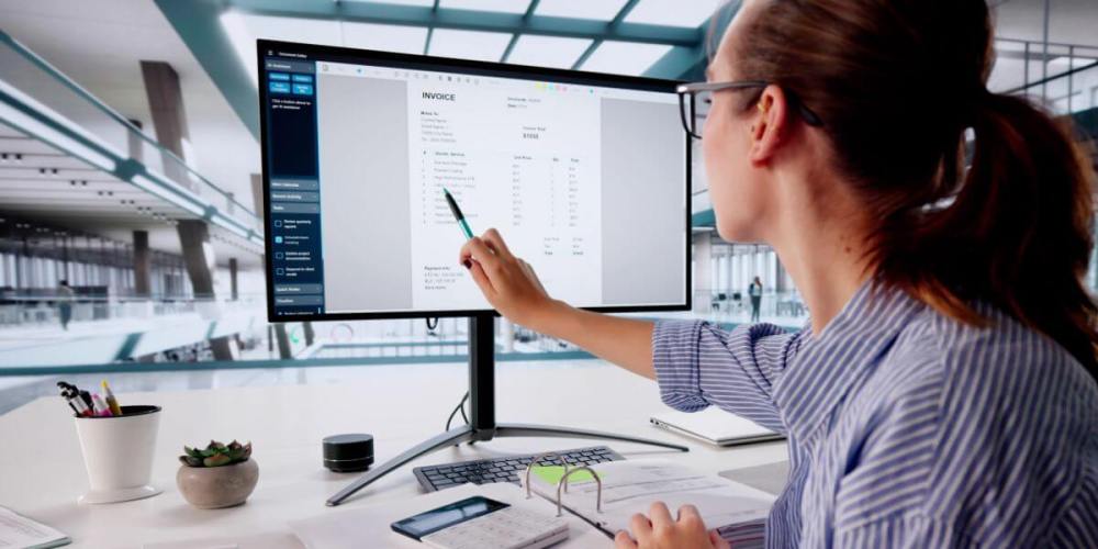 Woman pointing at a screen depicting an invoice