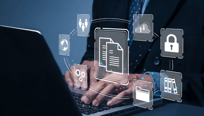 Man typing on his computer with graphics floating in front of the screen