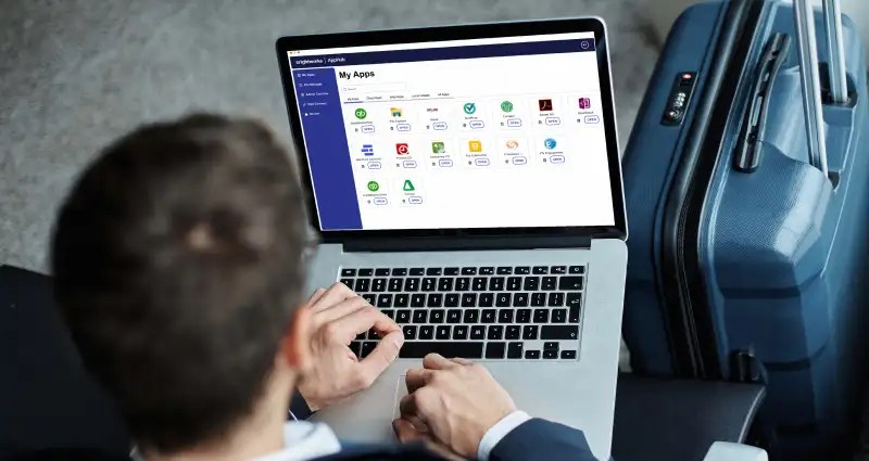 Person using a laptop with app dashboard shown on the screen
