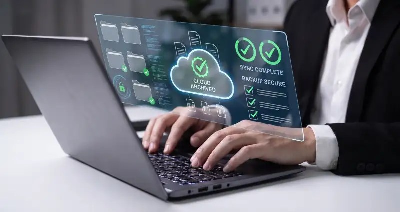 User with hands on a laptop keyboard with security dashboard shown above